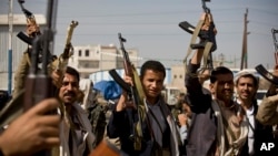 Brazilian Navy Academy students sit on a boat&#39;s mast during a ceremony marking the arrival of the Olympic flame at their Academy in Rio de Janeiro ahead of the Rio 2016 Olympic Games.