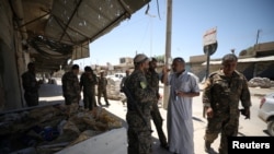 2017年5月12日，敘利亞民主軍戰鬥人員在本周從伊斯蘭國手中奪回的敘利亞城鎮塔布卡集結。