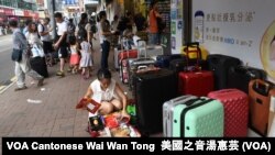 上水街頭隨處可見店舖外堆滿中國遊客及水貨客的「行李箱陣」 (美國之音湯惠芸)