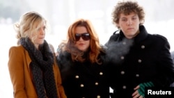 FILE - Lisa Marie Presley, center, with children Riley, left, and Benjamin Keough, attend the 75th birthday celebration for Elvis Presley in Memphis, Tennessee, Jan. 8, 2010. Presley was vocal about her grief over the death of Benjamin by suicide in 2020 at age 27.