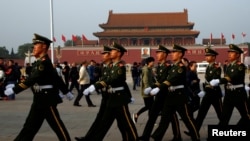  中共第十八届六中全会10月25日在北京召开第二天会议时，武警迈步通过天安门广场。