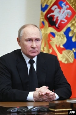 In this photograph distributed by the Russian state agency Sputnik, Russia's President Vladimir Putin delivers his address in Moscow on March 23, 2024, the day after a gun attack on the Crocus City Hall in suburban Moscow.