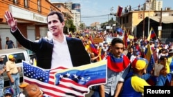 委内瑞拉马拉开波，反对派支持者手持委内瑞拉反对派领袖瓜伊多的纸板，参加反对总统马杜罗政府的集会。（2019年2月12日）