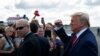 U.S. President Donald Trump pumps his fist as he arrives at Ocala International Airport in Ocala, Fla., Oct. 3, 2019.
