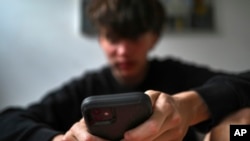 วัยรุ่นใช้มือถือเข้าถึงโซเชียลมีเดีย ในนครซิดนีย์ ออสเตรเลีย 13 พ.ย. 2024 (Dean Lewins/AAP Image VIA AP)