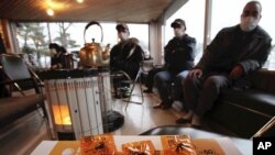 A Syrian independence flag and the damaged customs office at Syria's Tel Abyad border gate are pictured from the Turkish town of Akcakale, October 5, 2012. 