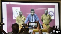 烏干達歌手出身的反對派議員博比瓦恩2019年5月2日視頻“出庭”。瓦恩原名羅伯特森塔穆，他常因批評總統穆塞韋尼而被捕。《華爾街日報》的報道說，警方與華為公司員工合作破解了瓦恩的通訊工具