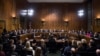 President Donald Trump's Supreme Court nominee, Brett Kavanaugh, takes notes as the Senate Judiciary Committee members make opening statements during his confirmation hearing, on Capitol Hill in Washington, Sept. 4, 2018.