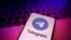FILE - The Telegram app logo is seen on a phone against the backdrop of a keyboard in an illustration photo taken Aug. 27, 2024.