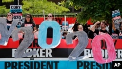 Supporters for Democratic presidential candidate Cory Booker hold signs outside the Iowa Democratic Party's Hall of Fame Celebration, June 9, 2019, in Cedar Rapids, Iowa.
