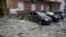 Damaged cars are parked in the yard amid debris after a Russian drone hit a multistory apartment house in Kyiv, Ukraine, Jan. 10, 2025. 