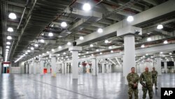 U.S. National Guard members stand at the Jacob Javits Center, March 23, 2020, in New York.