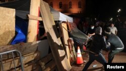 在加州大学洛杉矶分校，反抗议者冲击一座支持巴勒斯坦人的抗议营地外围的障碍物。(2024年5月1日)