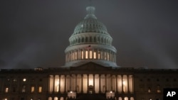 The U.S. Capitol in Washington is shrouded in mist, Friday night, Dec. 13, 2019, at the end of an acrimonious week of partisan disputes in the House Judiciary Committee which approved two articles of impeachment against President Donald Trump,…