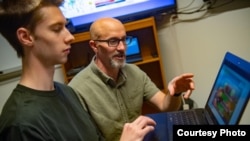 Luke Trinity and Scott Merrill are part of a team of University of Vermont researchers using video games and computational models to understand human behavior. (Sally McCay/University of Vermont)