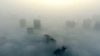 Buildings are seen on a hazy day in Xiangyang, Hubei province, China, Dec. 31, 2016. The current round of air pollution struck Friday and isn't expected to lift until Thursday.