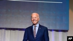 FILE - Former Vice President Joe Biden arrives on stage at the South Carolina Democratic Party convention, June 22, 2019 in Columbia, S.C.. 
