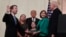President Donald Trump, center, listens as retired Supreme Court Justice Anthony Kennedy, right, ceremonially swears-in Supreme Court Justice Brett Kavanaugh, left, in the East Room of the White House in Washington, Oct. 8, 2018. 