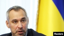 FILE - Ukraine's Prosecutor General Ruslan Ryaboshapka speaks during a news conference in Kyiv, Ukraine, Oct. 4, 2019. 