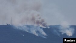 ຄວັນ​ປິວ​ຂຶ້ນ​ທ້ອງ​ຟ້າ ທ່າມ​ກາງ​ການ​ຕໍ່​ສູ້​ກັນ​ລະ​ຫວ່າງ​ກຸ່ມ ເຮັ​ສ​ໂບ​ລ​ລາ ກັບ ກອງ​ກຳ​ລັງ ອິ​ສ​ຣາ​ແອ​ລ, ເມືອງ ທາຍ​ເອີ, ພາກ​ໃຕ້​ຂອງ ເລ​ບາ​ນອນ, 22 ຕຸ​ລາ 2024.REUTERS/Aziz Taher