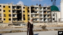 Nisrin Malaji returns to her looted home in the Hanano district of eastern Aleppo, Syria, Dec. 4, 2016.