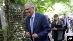 Washington Gov. Jay Inslee heads out after speaking with reporters about his plans to run for a third term, Aug. 22, 2019, in Seattle. Inslee ended his climate change-focused 2020 presidential bid a day earlier. 
