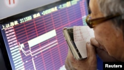 中國股市2016年1月7日再度觸發熔斷後，一名投資者盯著股市信息屏幕 