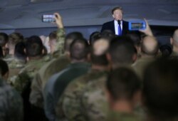 FILE - President Donald Trump speaks to members of the U.S. military at Elmendorf Air Force Base in Anchorage, Alaska, Feb. 28, 2019.