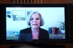 FILE - Merck Executive Vice President and Chief Patient Officer Julie Gerberding is seen on a screen as she gives a statement during a Senate Health, Education, Labor and Pensions Committee hearing, June 23, 2020, on Capitol Hill in Washington.