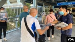 元朗區議員林進（右）及多名天水連線成員8月11日早上7時開始在天水圍西鐵站，免費向市民派發超過1千份蘋果日報。(美國之音湯惠芸)