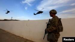 美軍在伊拉克摩蘇爾襲擊伊斯蘭國武裝分子的行動中，一名美國陸軍士兵手持武器站在摩蘇爾附近地區的軍事基地。2016年10月18日拍攝。 （路透社照片）