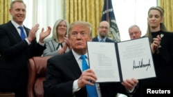 美國總統特朗普在白宮橢圓形辦公室展示了“第4號航天政策令”。(2019年2月19日) 